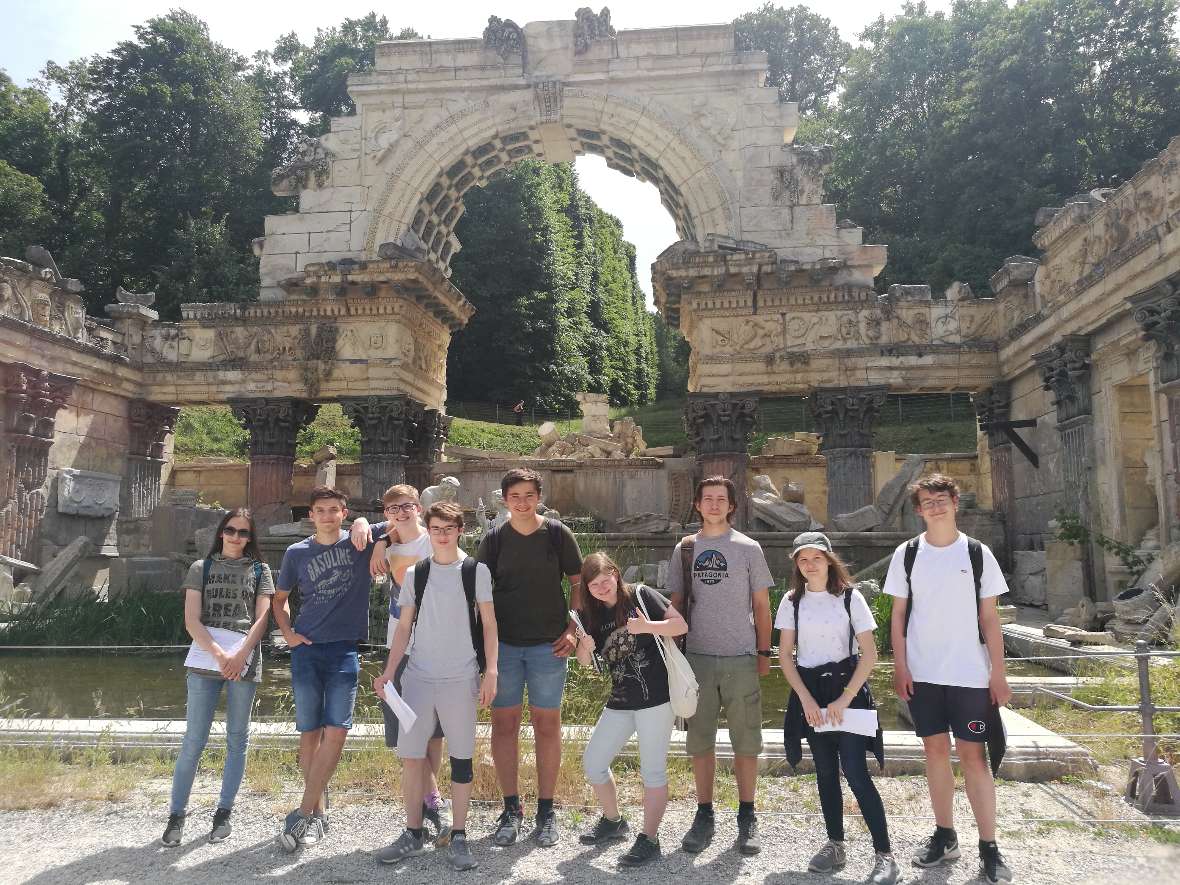 Schülerinnen und Schüler posieren vor der Römischen Ruine