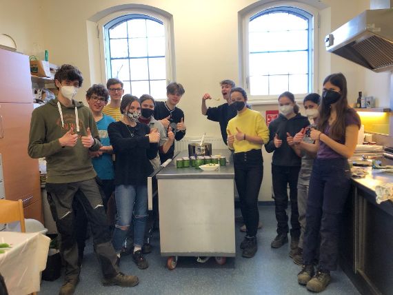 Schülerinnen und Schüler stehen in der Küche der Außenstelle Kammermeierei der Schule und verkosten ihr selbstgemachtes Bärlauchpesto